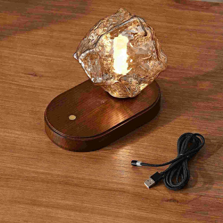 Ice Stone Rechargeable Table Lamp on wooden base with USB cable, ideal for bedside and coffee table use.
