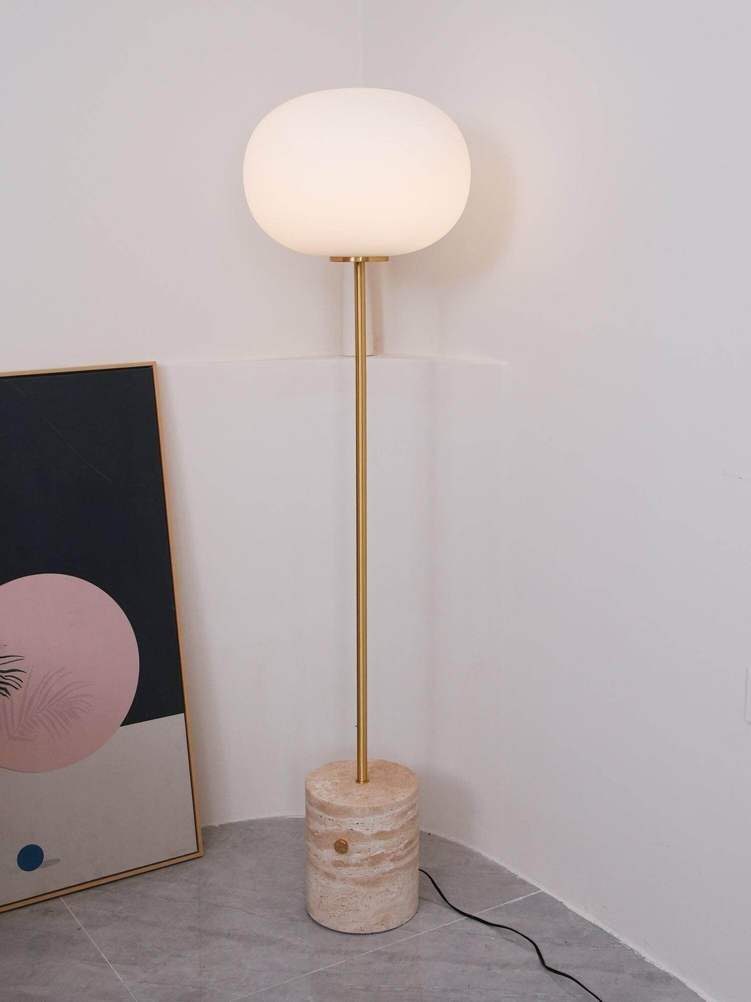 Modern JWDA floor lamp in corner, featuring a round white shade and marble base, perfect for living rooms and reading.