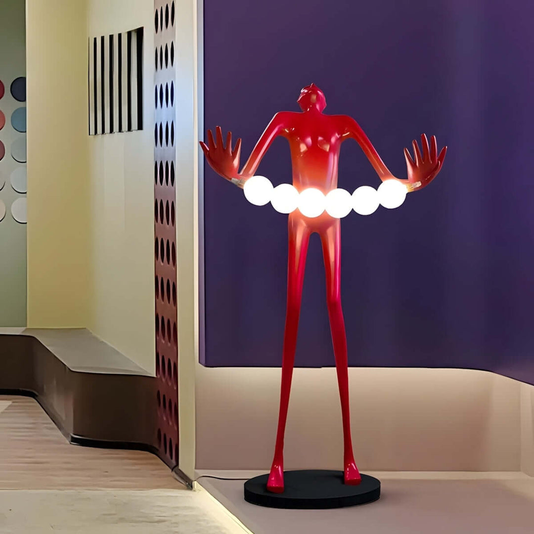 Sculptural floor lamp with a red figure holding white globes, adding a bold touch to modern living room decor.