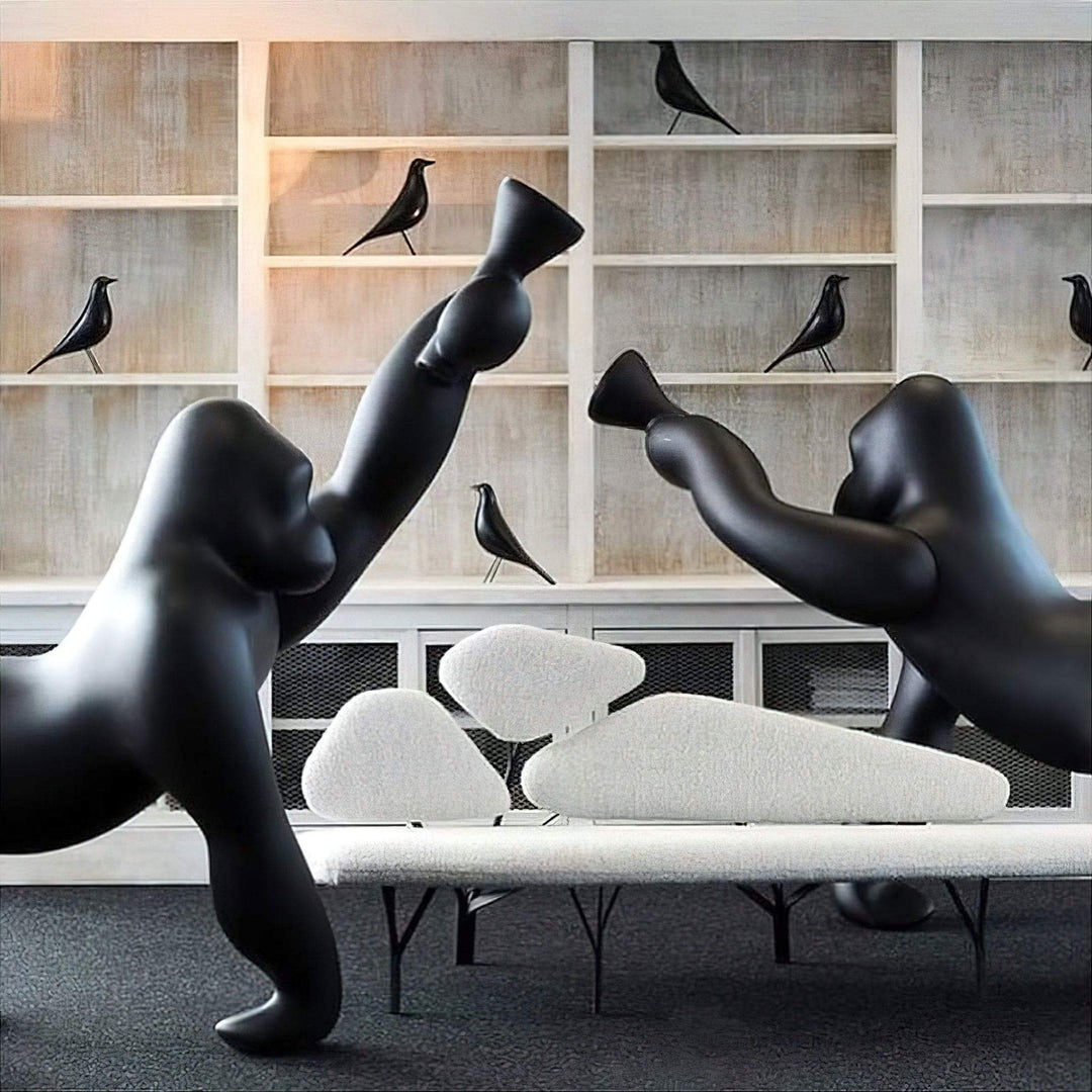 Artistic black gorilla sculptures in a modern living room setting, showcasing unique design and contemporary decor.