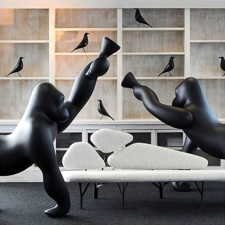 Artistic black gorilla sculptures in a modern living room setting, showcasing unique design and contemporary decor.