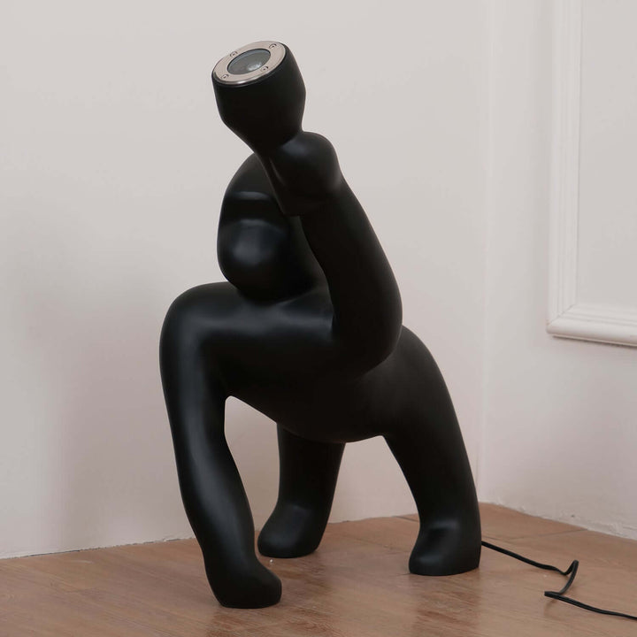 Kong sculpture floor lamp in black, showcasing a unique design, perfect for art deco decor and living room lighting.