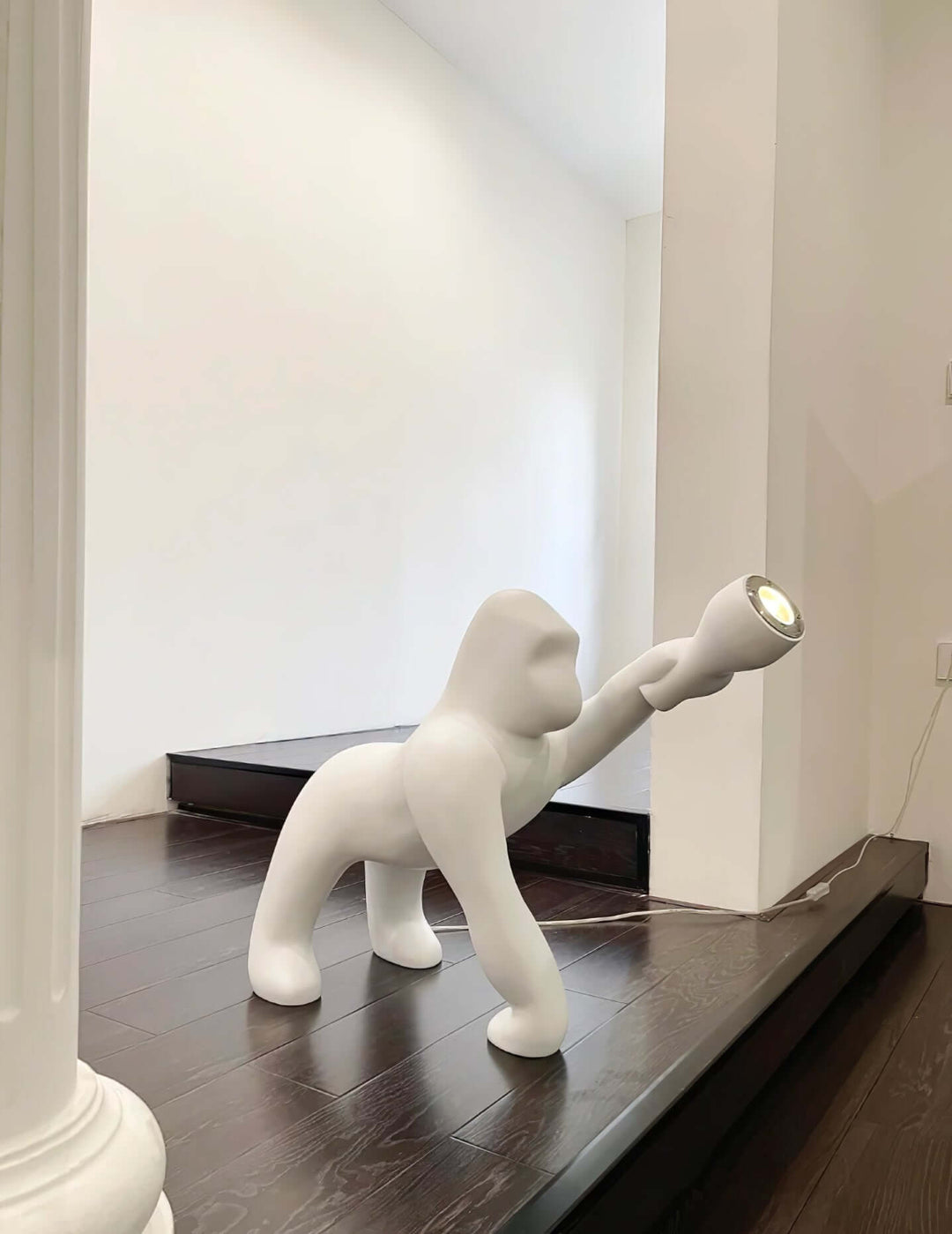 Kong Sculpture Floor Lamp in white, a unique sculptural floor lamp illuminating a modern living space.
