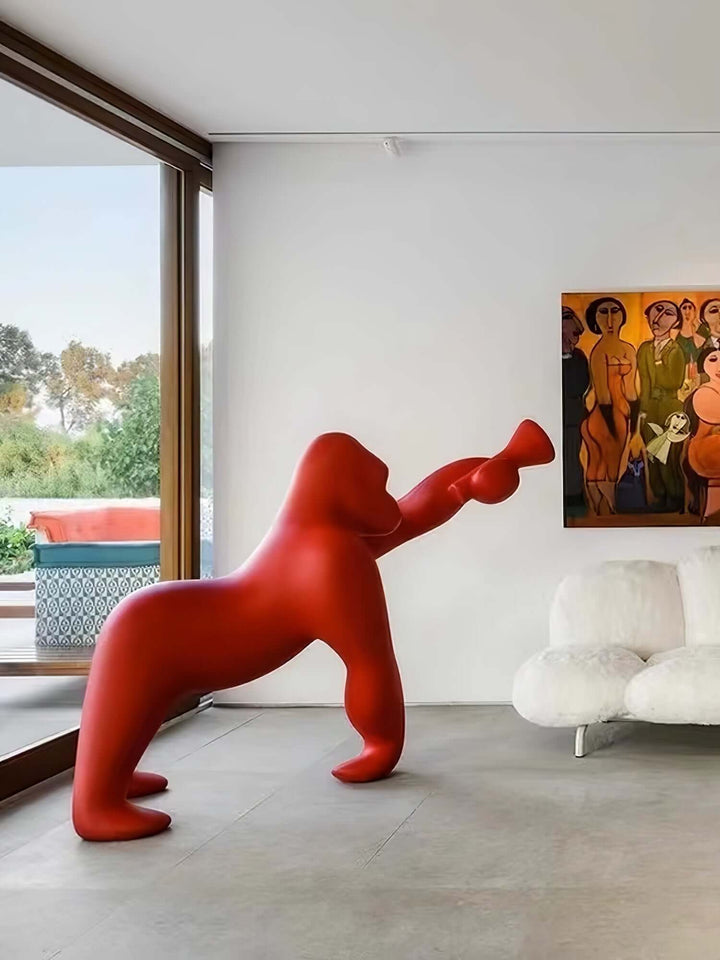 Red Kong sculpture in modern living room, showcasing contemporary art and playful design elements.