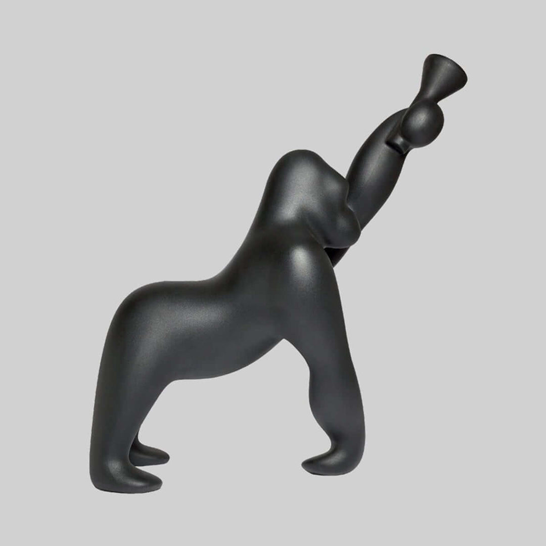 Black sculptural floor lamp resembling a sleek gorilla silhouette, perfect for adding art deco style to any living room.