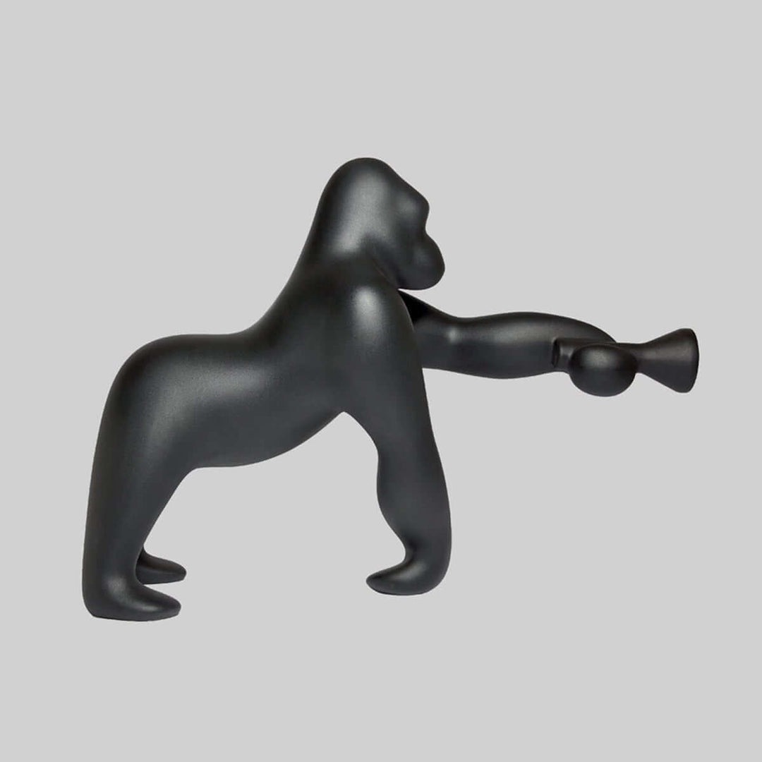 Sculptural floor lamp shaped like a gorilla, modern art deco design for unique living room decor.