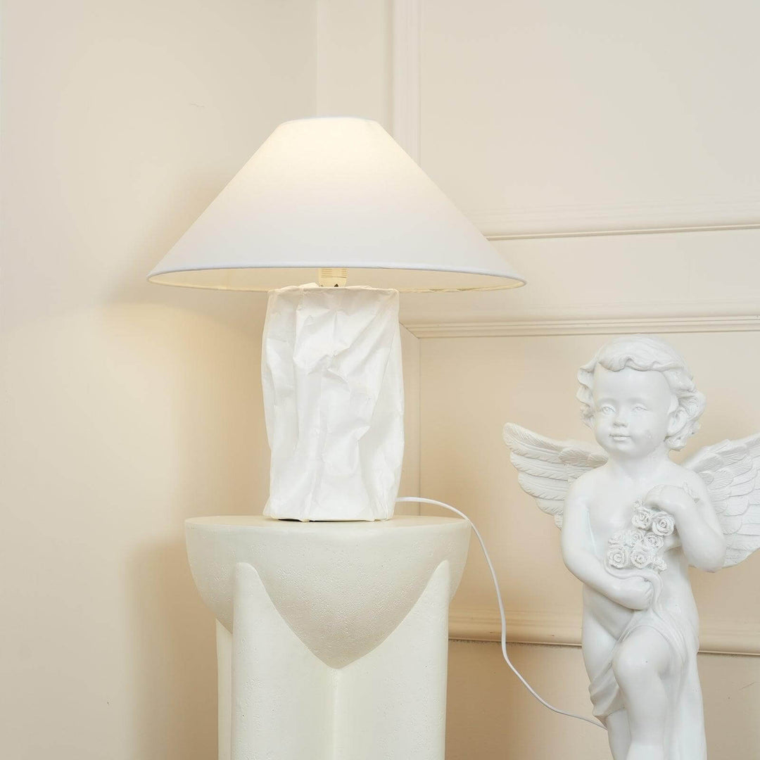 Minimal table lamp with white shade and crumpled paper base, ideal for bedroom bedside decor.
