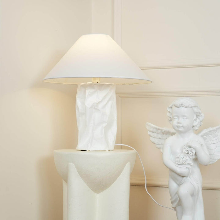 Minimal table lamp with white shade and crumpled paper base, ideal for bedroom bedside decor.