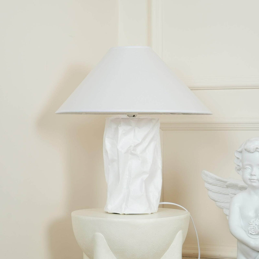 Minimal table lamp with white shade and textured base, perfect for bedroom bedside lighting.