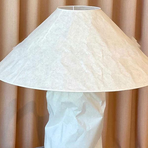 Minimal table lamp with a white paper shade, perfect for bedroom bedside decor.