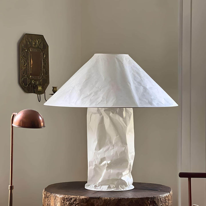 Minimal white table lamp on a wooden table, ideal for bedroom or bedside use.