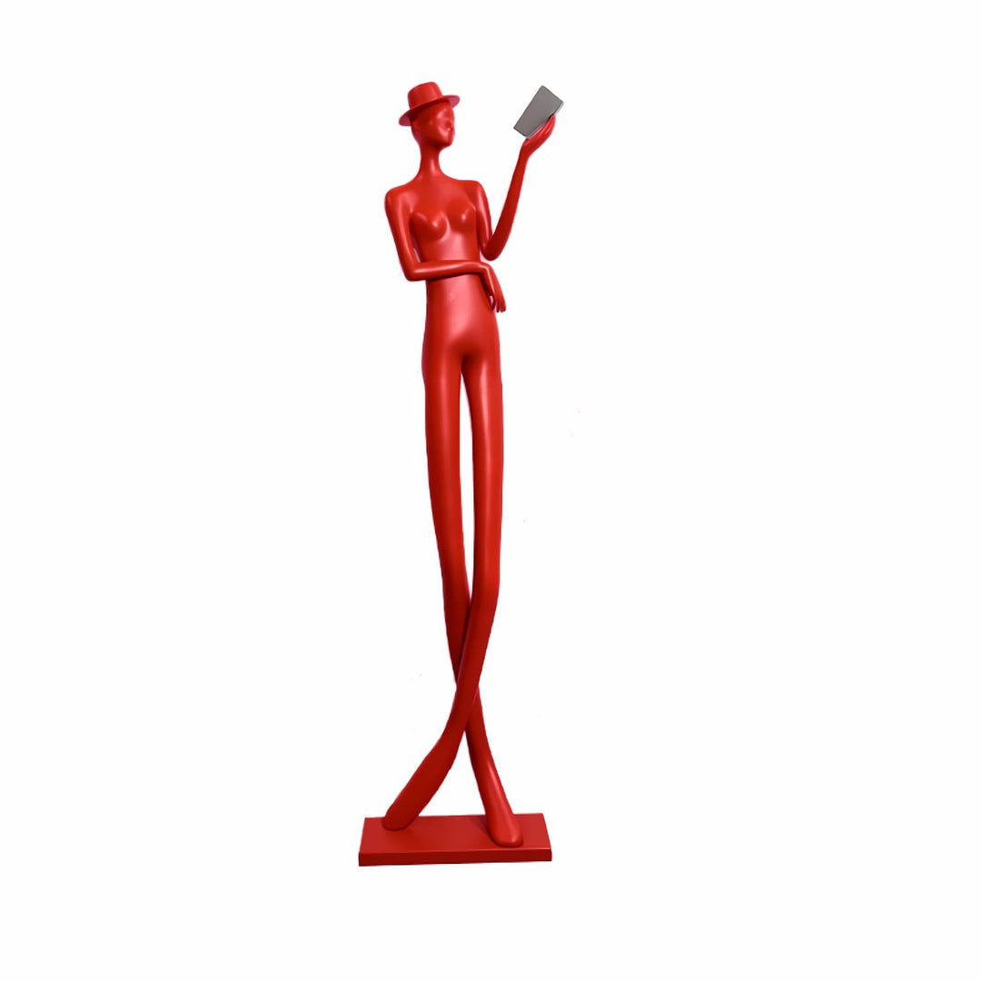 Sculptural floor lamp in red featuring a tall figure holding a book, perfect for art deco decor.