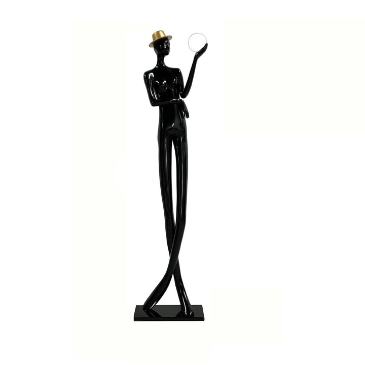 Lomexa sculptural floor lamp featuring a tall, elegant figure in black with a gold hat, perfect for stylish living room decor.