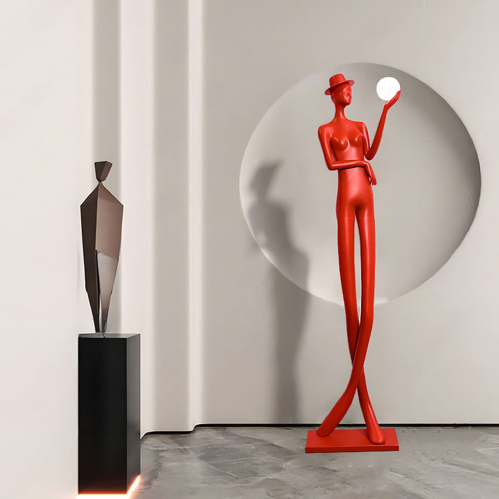 Sculptural floor lamp in vibrant red, showcasing art deco style, positioned in a modern living room setting.
