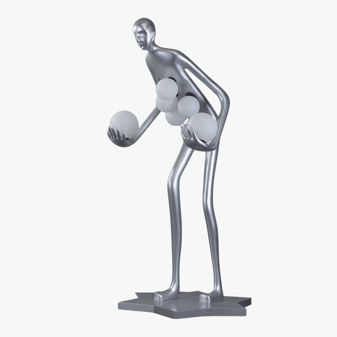Sculptural silver art deco floor lamp featuring a stylized figure holding illuminated orbs, perfect for modern living room decor.