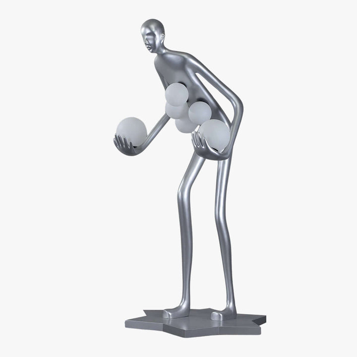 Sculptural silver art deco floor lamp featuring a stylized figure holding illuminated orbs, perfect for modern living room decor.