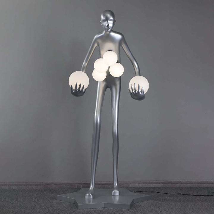 Sculptural floor lamp featuring a modern metallic figure holding multiple spherical lights, ideal for contemporary living room decor.