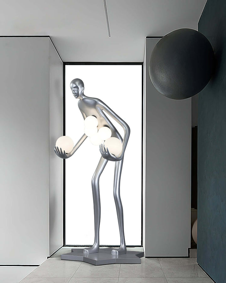 Sculptural floor lamp in a unique mannequin design, illuminating modern living space with artistic flair.