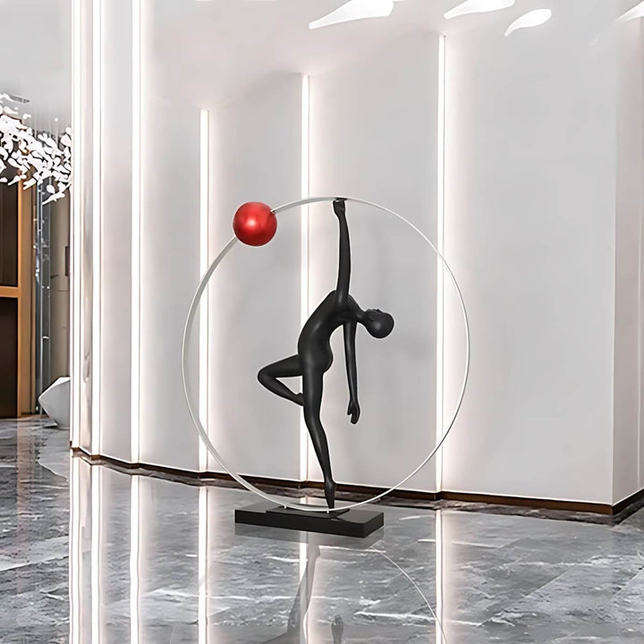 Art Deco resin sculpture in living room, decorative ornament with black figure and red ball, modern home decor.