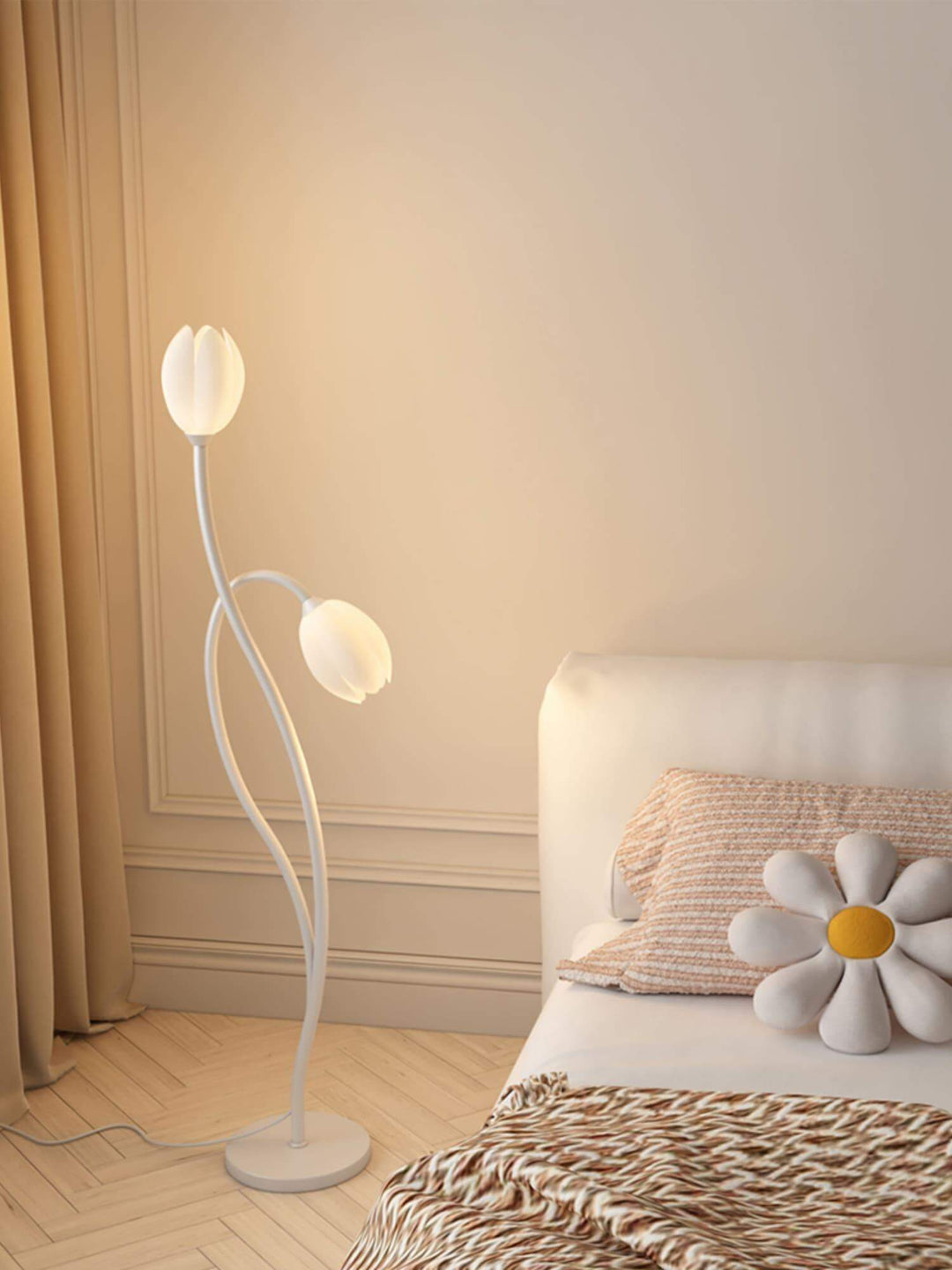 Modern Manta Flower Floor Lamp in white, features minimalist design, illuminating a cozy bedroom with floral accents.