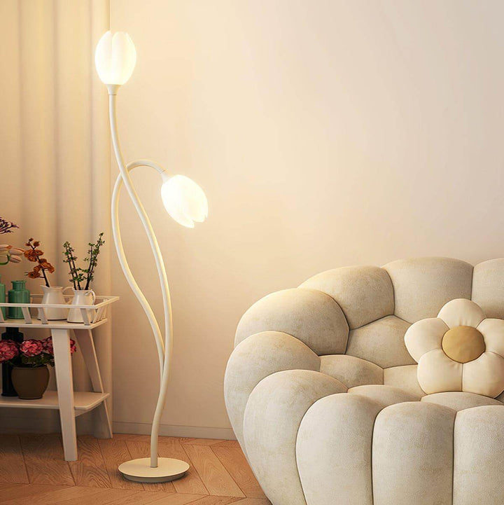 Manta Flower Floor Lamp in a minimalist living room, featuring a modern design with white metal accents and soft lighting.