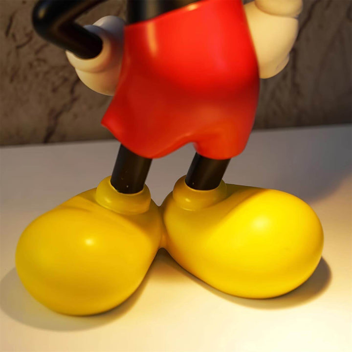 Close-up of Mickey Mouse's yellow shoes and red shorts, showcasing fun cartoon design elements.