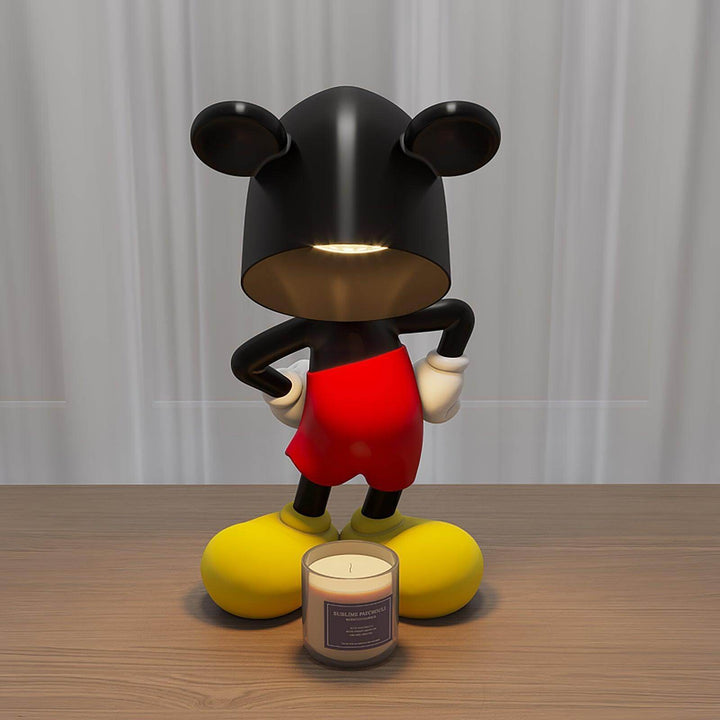 Mickey Table Lamp as a sculptural art deco design with black and red features on a wooden table, beside a candle.