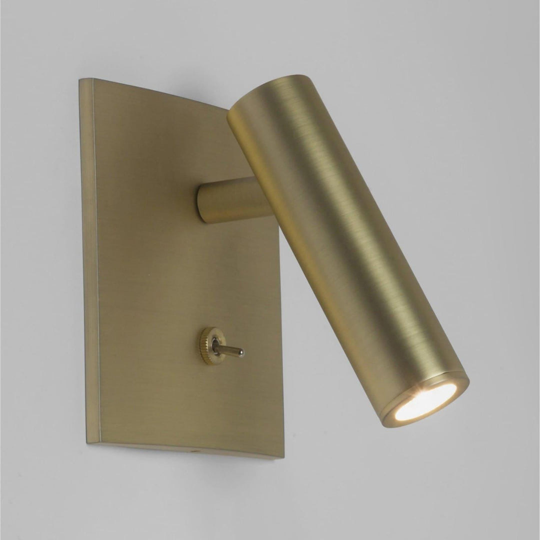 Modern brass flush mount wall sconce, ideal for reading or as bedside wall lights, featuring a minimalist design.
