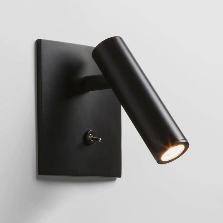 Minimalist flush mount wall sconce in black, perfect as a wall mount reading lamp or bedside wall light.