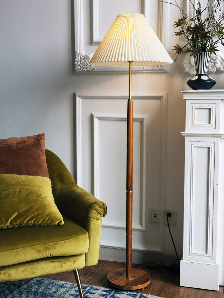 Mid century pleated floor lamp in a stylish living room with green couch, perfect for modern decor.