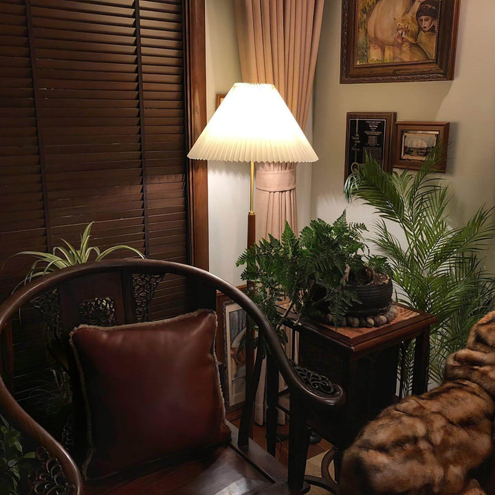 Mid century pleated floor lamp in a cozy living room, highlighting trendy wooden floor light and lush plants.