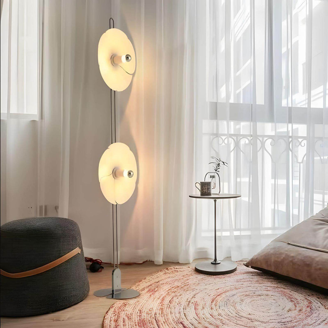Art Deco 2093 whimsical floor lamp, adding elegance to a contemporary living space with soft yellow glow.
