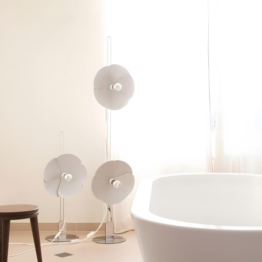 Whimsical Art Deco floor lamp trio in white, illuminating a bright bathroom space with elegant design.
