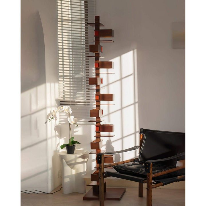 Tall Taliesin Floor Lamp in art deco style, wooden design illuminating a modern living room space.