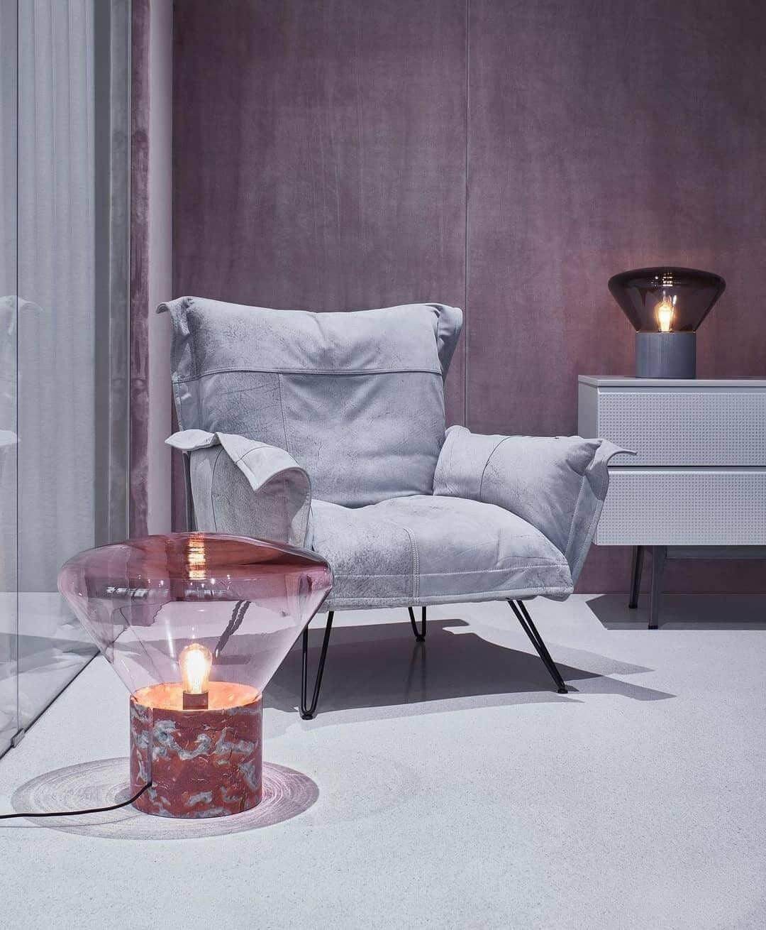 Art deco Muffins table lamp beside a stylish gray armchair in a modern living room setting.