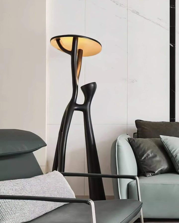 Sculptural art deco floor lamp in a modern living room setting, enhancing chic interior design.