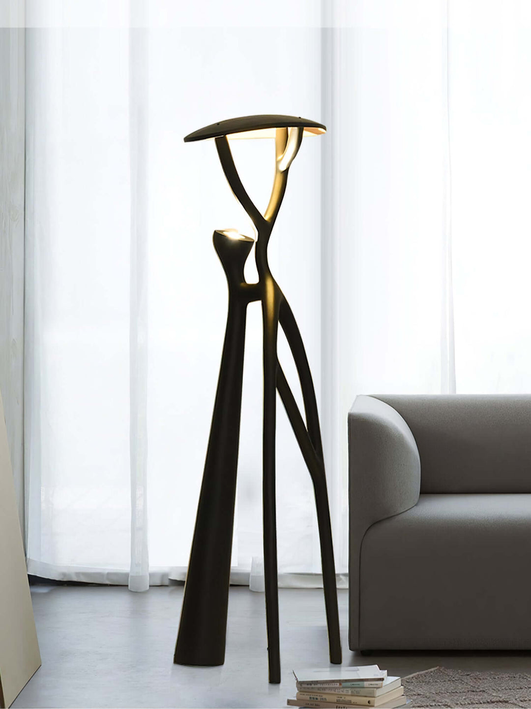 Sculptural Nivaro resin floor lamp with art deco design, illuminating living room with modern tripod style.