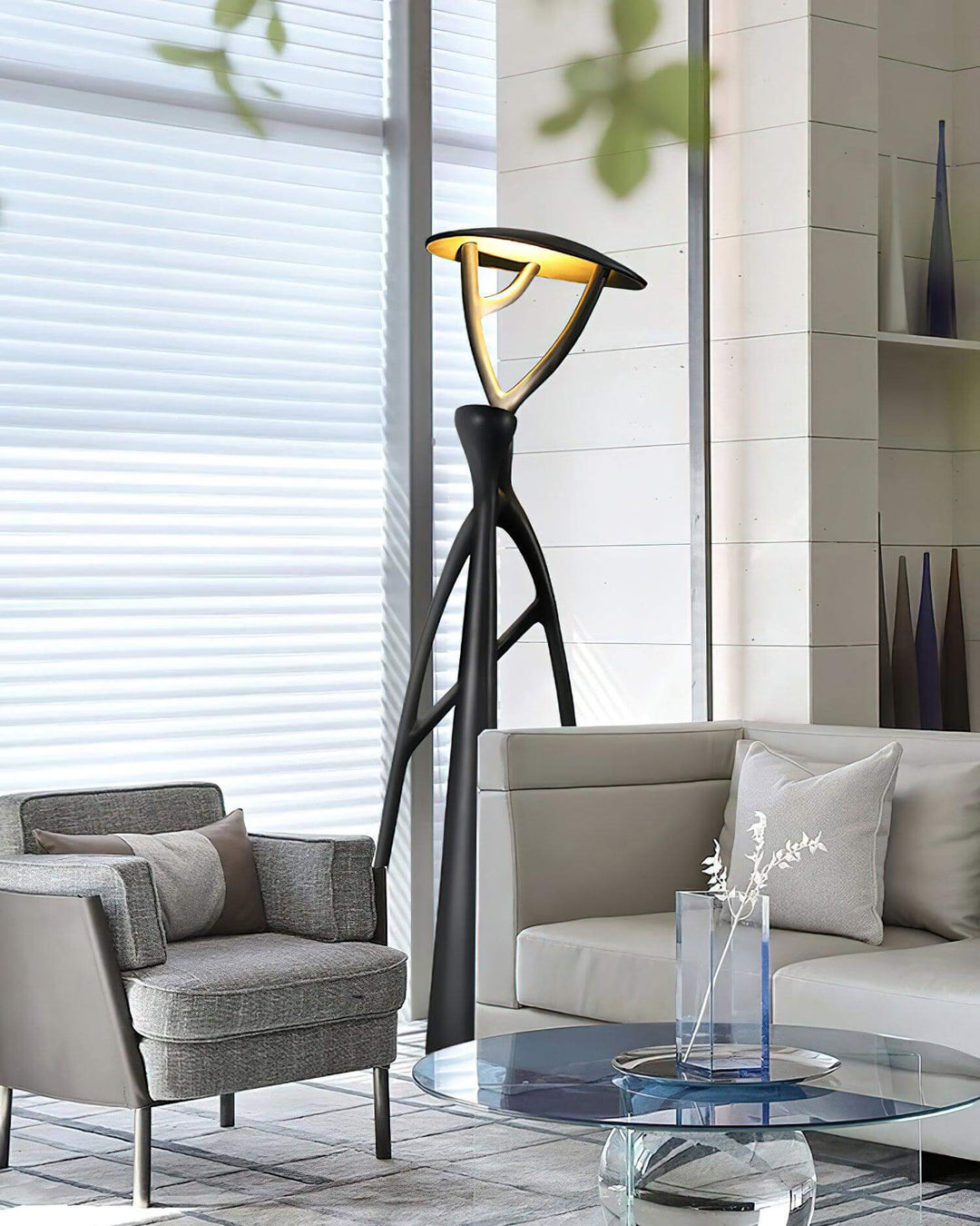 Stylish sculptural Nivaro floor lamp enhancing modern living room with tripod design and sleek art deco flair.