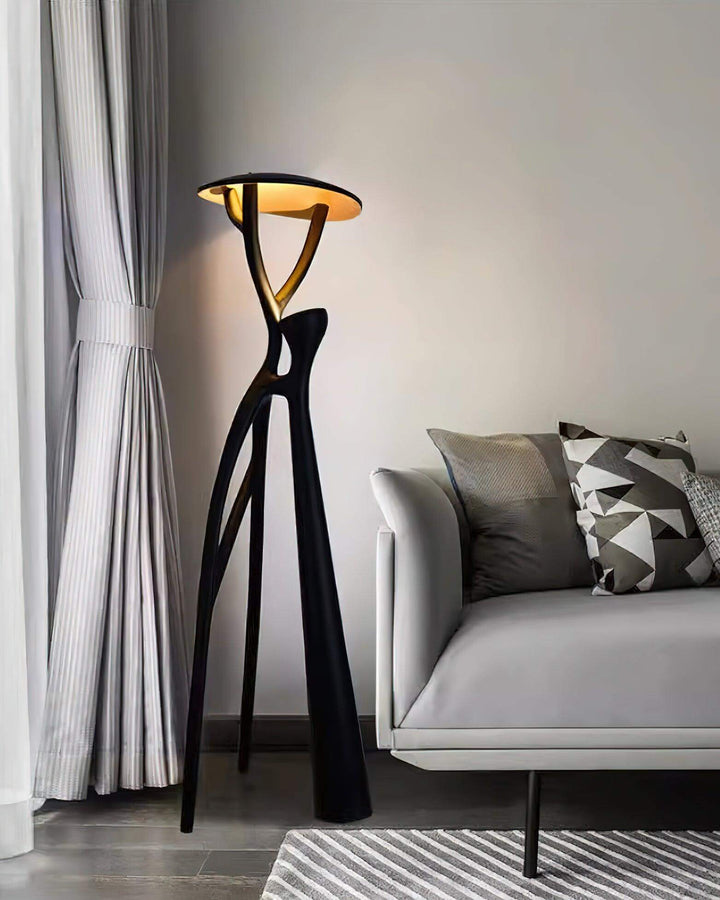 Sculptural Nivaro resin floor lamp in modern living room, featuring art deco design and tripod base.