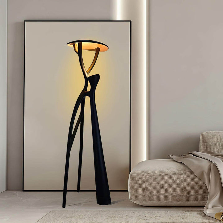 Nivaro sculptural floor lamp in living room, featuring a modern art deco design and elegant tripod style.