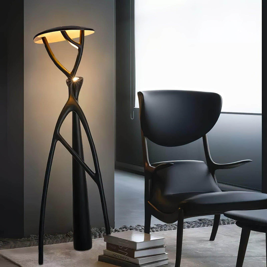 Sculptural resin floor lamp next to a stylish black chair in a modern living room setting.