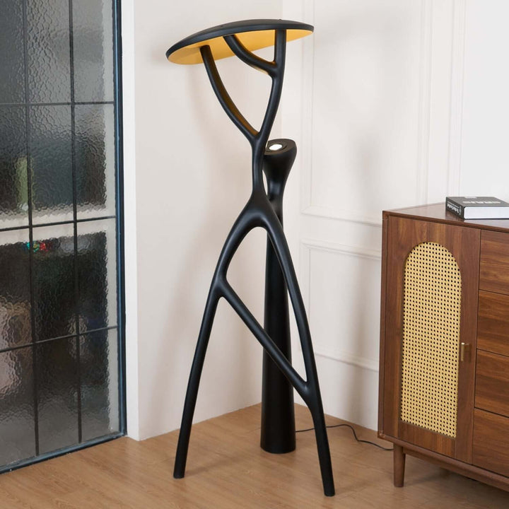 Nivaro sculptural floor lamp with black finish and yellow top, ideal for art deco living room decor.