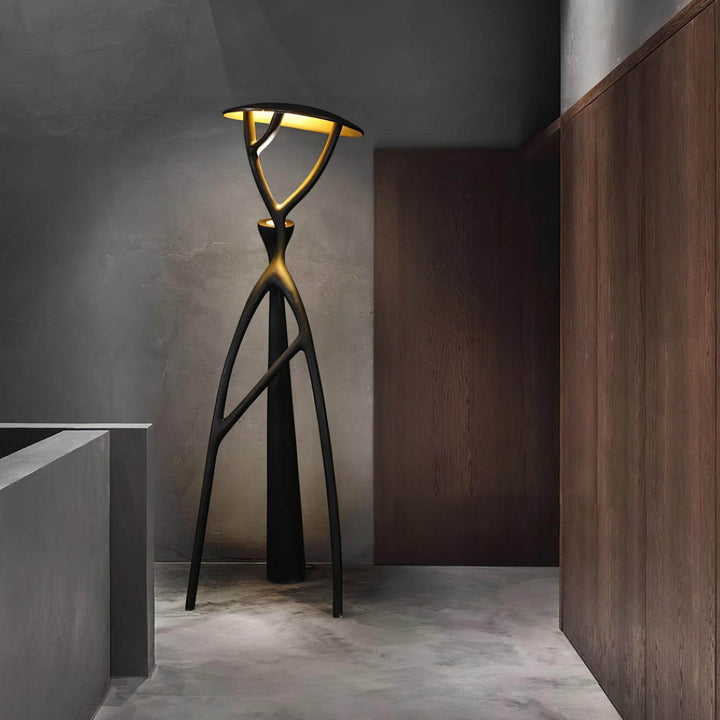 Sculptural floor lamp with tripod design, ideal for living room lighting in modern interiors.
