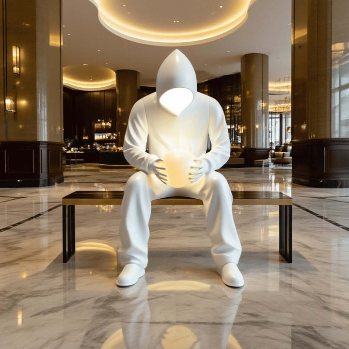 Sculptural floor lamp featuring a hooded figure, adding artistic flair as a centerpiece in modern living spaces.