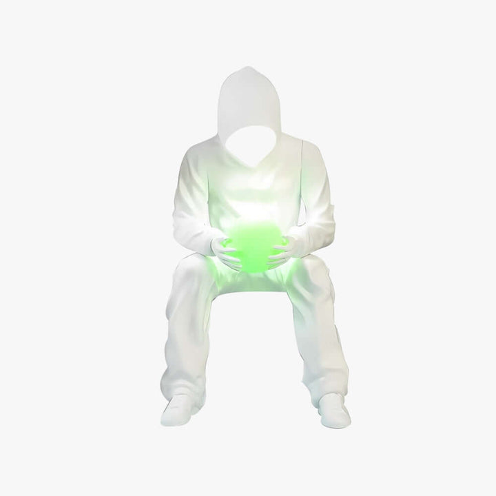 Sculptural floor lamp design featuring a seated figure holding a glowing green orb, perfect for modern living spaces.