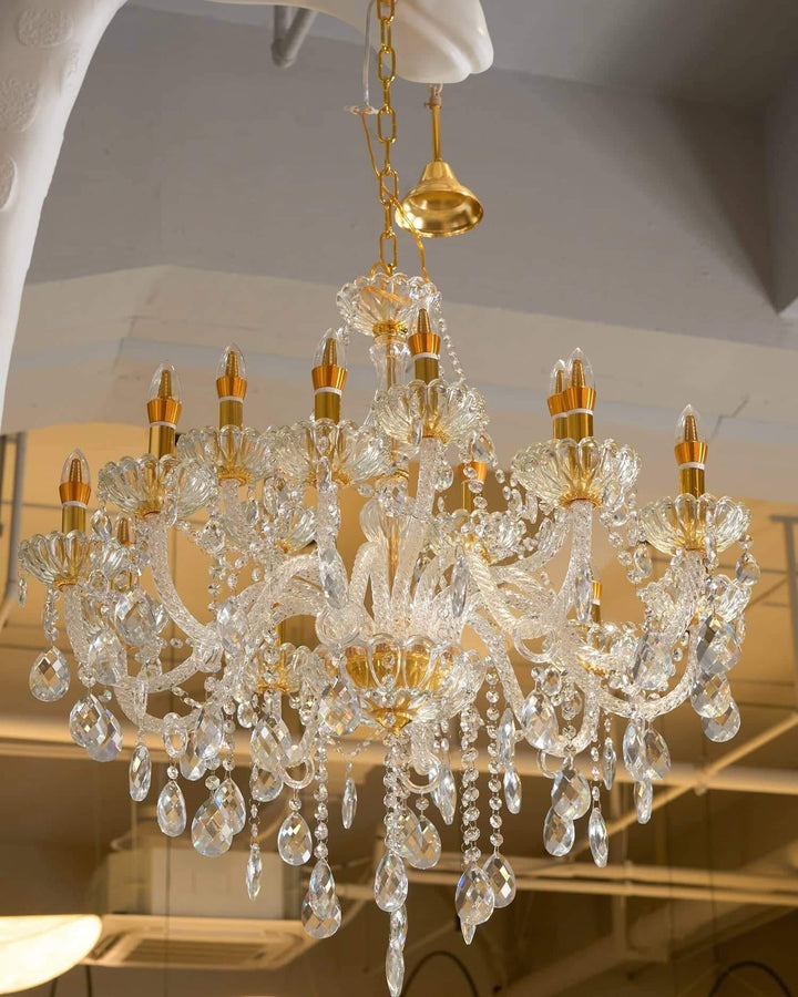 Elegant crystal chandelier with gold accents, ideal for enhancing luxurious interiors.