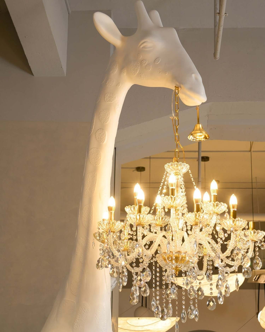 Nuvexa Giraffe Floor Lamp with chandelier hanging from the giraffe's mouth, adding a whimsical touch to modern decor.
