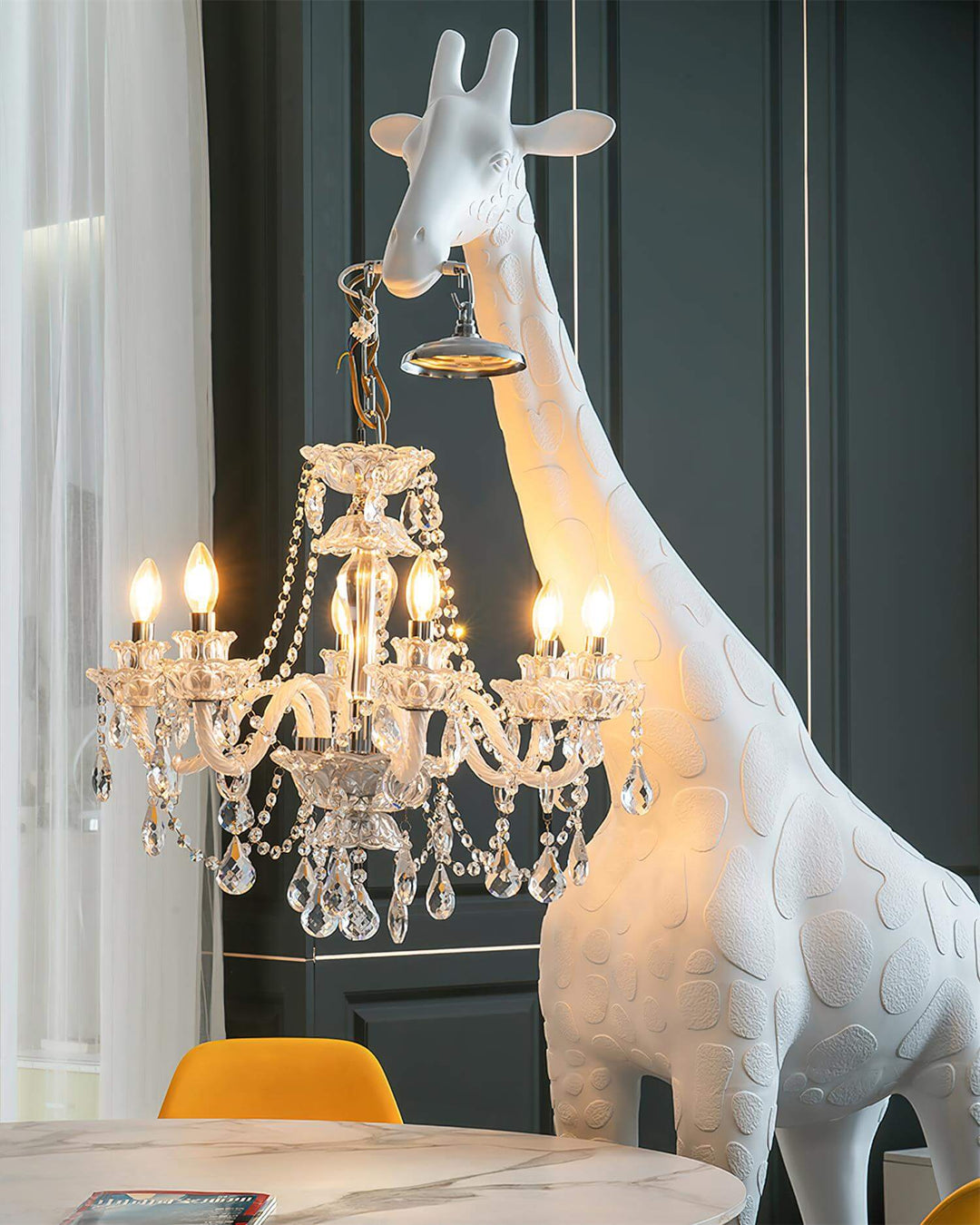 Nuvexa giraffe floor lamp featuring an elegant chandelier, adding a sculptural art deco touch to modern living room decor.