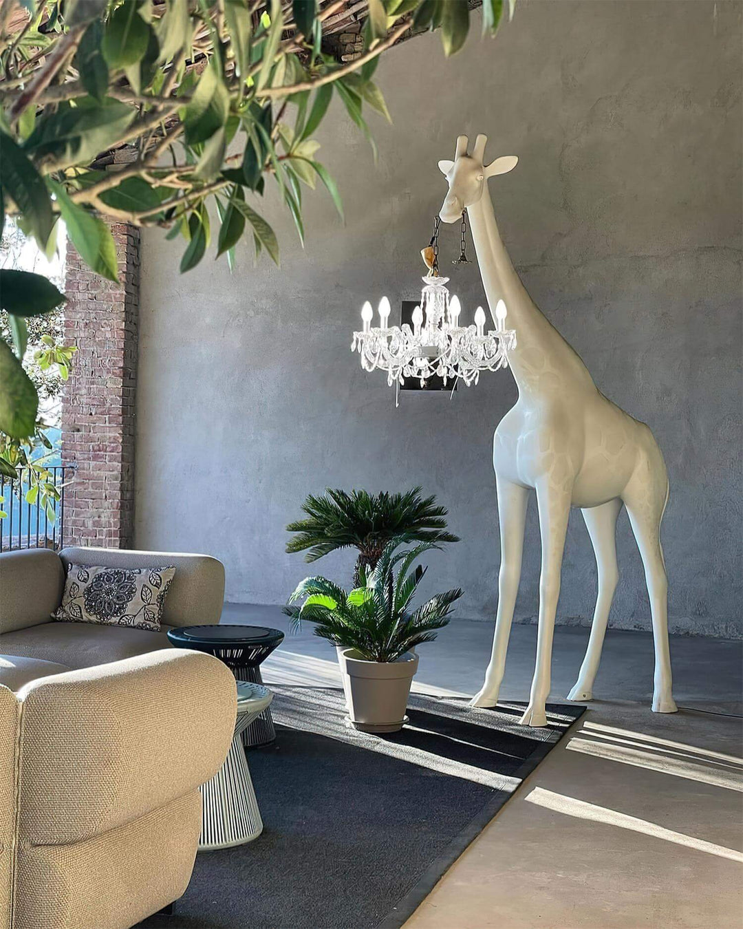 Sculptural giraffe floor lamp with a chandelier, modern décor for a stylish living room.