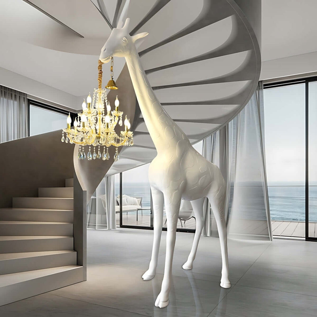 Nuvexa giraffe floor lamp in a modern living room with spiral staircase and chandelier, showcasing artistic design.